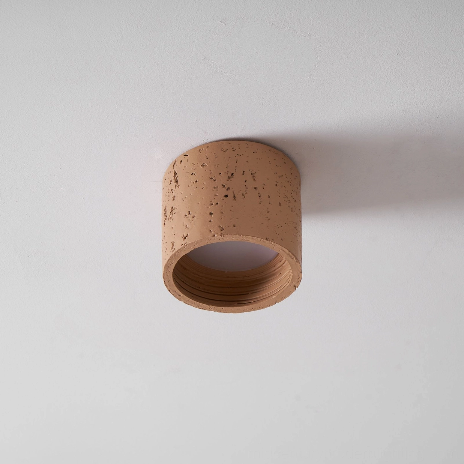 Carso ceiling pendant in warm minimalist interior, tactile surface design
