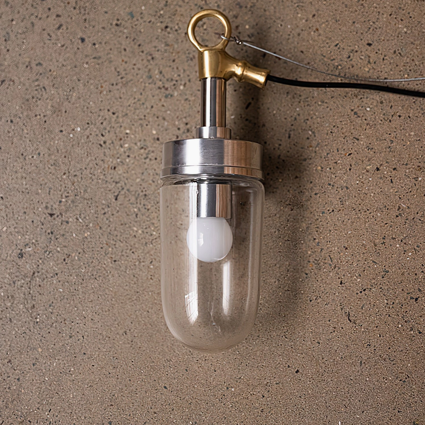 Carson Capsule Pendant Light front view with brass hanging hook mixed metal finish textured backdrop