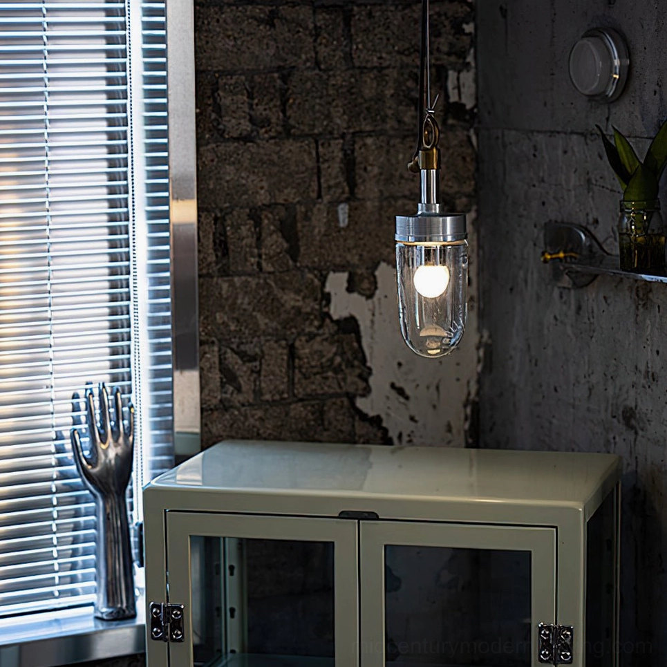 Carson Capsule mid-century modern pendant light in industrial home studio with metal cabinet decor