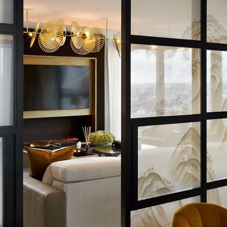 Cascade fan chandelier architectural detail showing hand-finished brushed gold metal fan elements