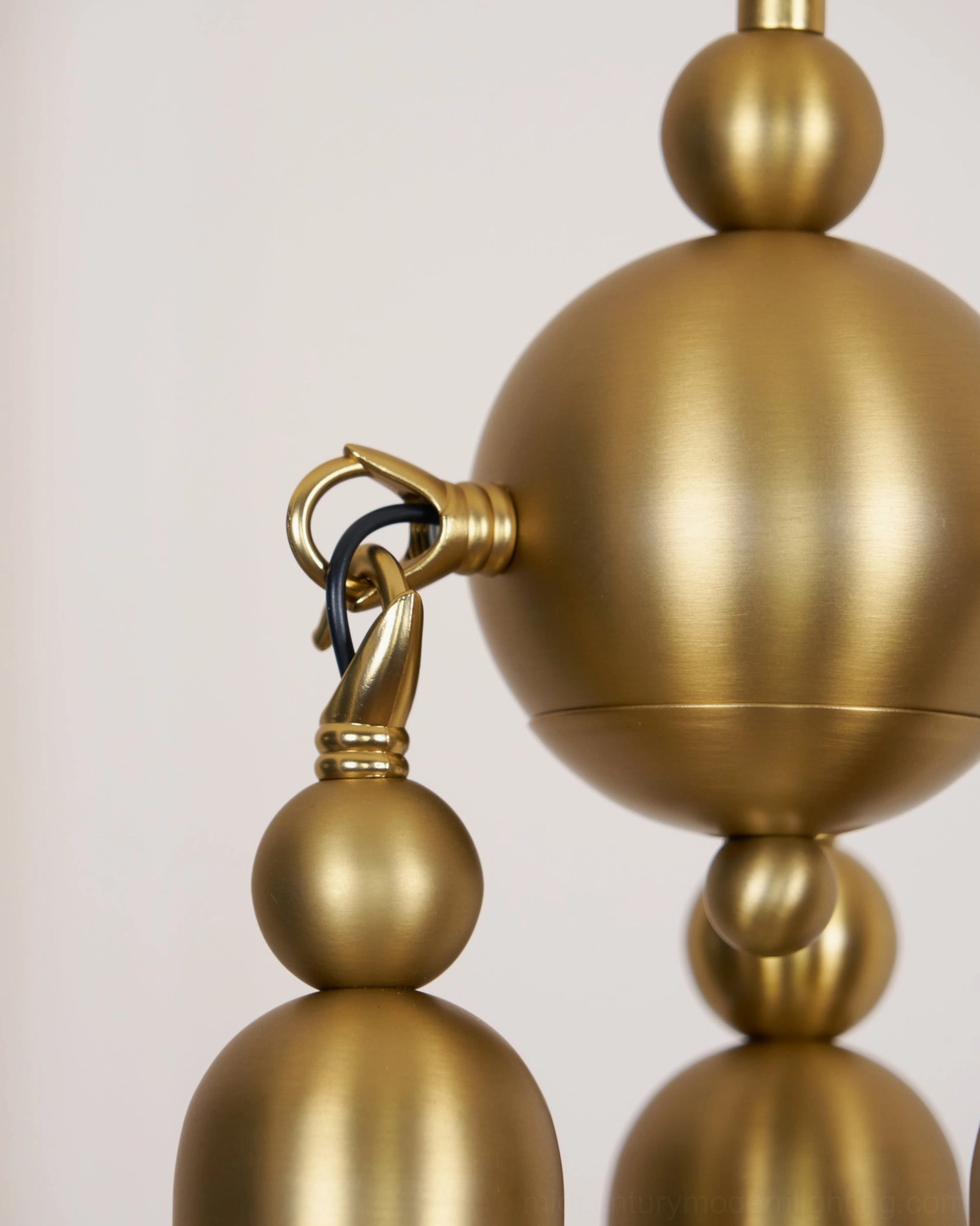 Detailed view of Cascadia pendant suspension mechanism showing stacked spherical brass components and metal joints