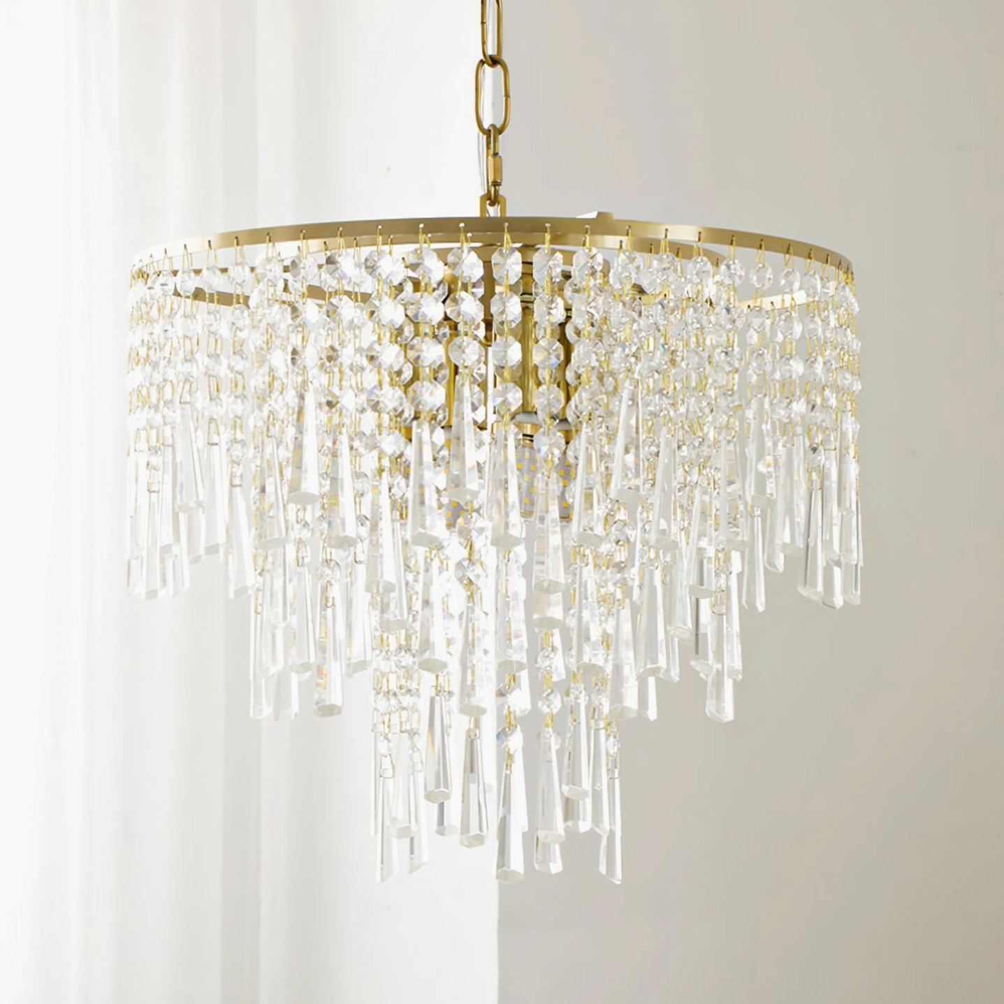 Wide-format cascading crystal pendant chandelier with full coverage of clear crystal pendants and brass gold suspension chain