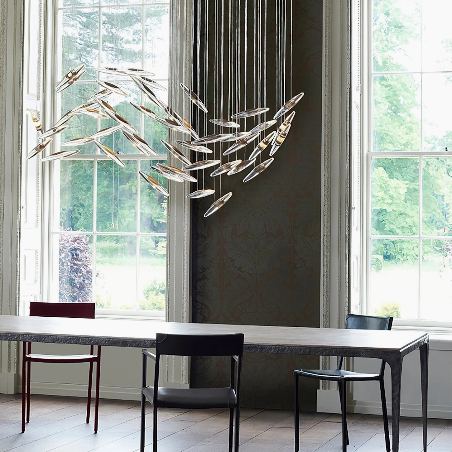 Cascading glass pendant chandelier with warm golden tones in contemporary interior space