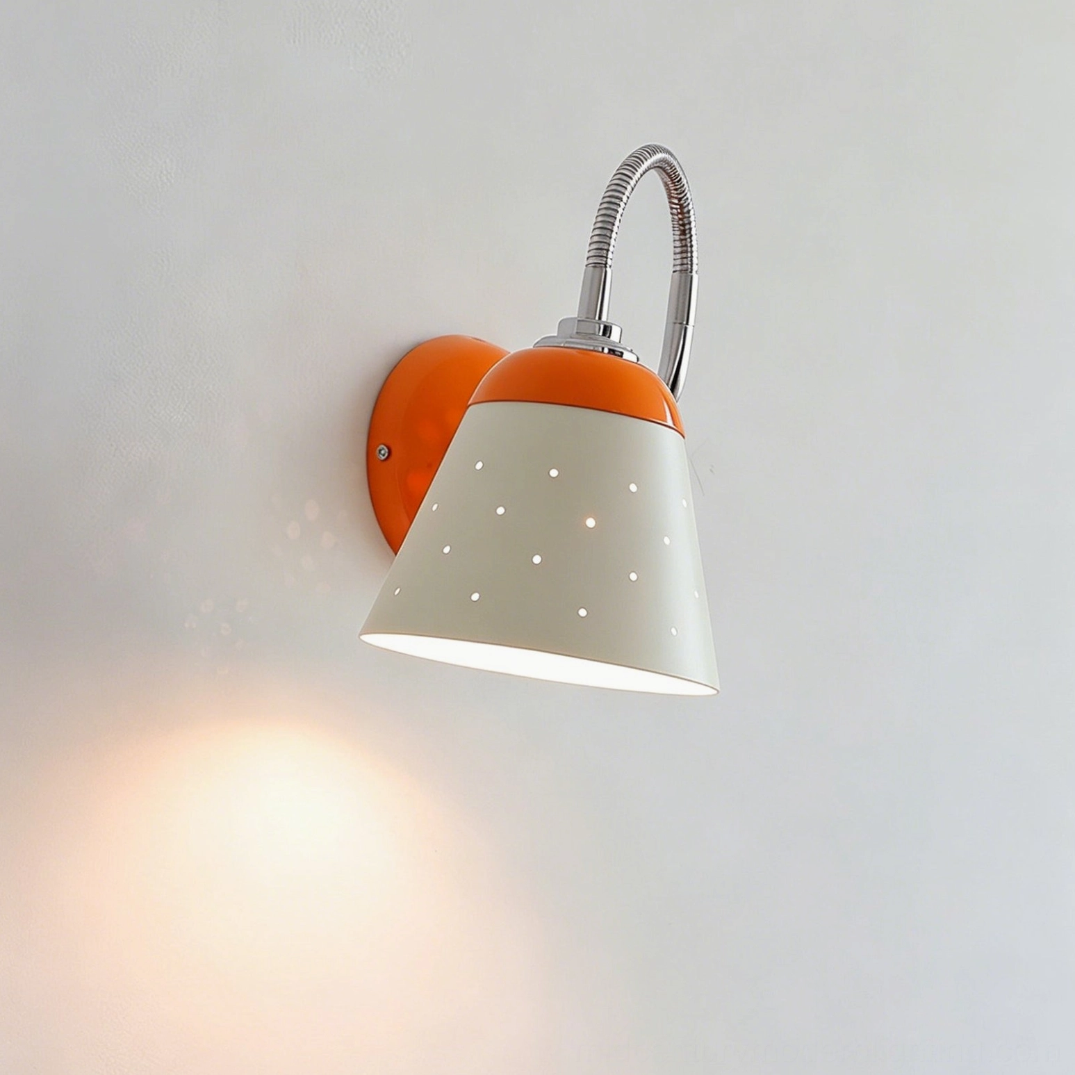 Casper wall-mounted sconce, orange and black, illuminated in interior setting, modern task lamp