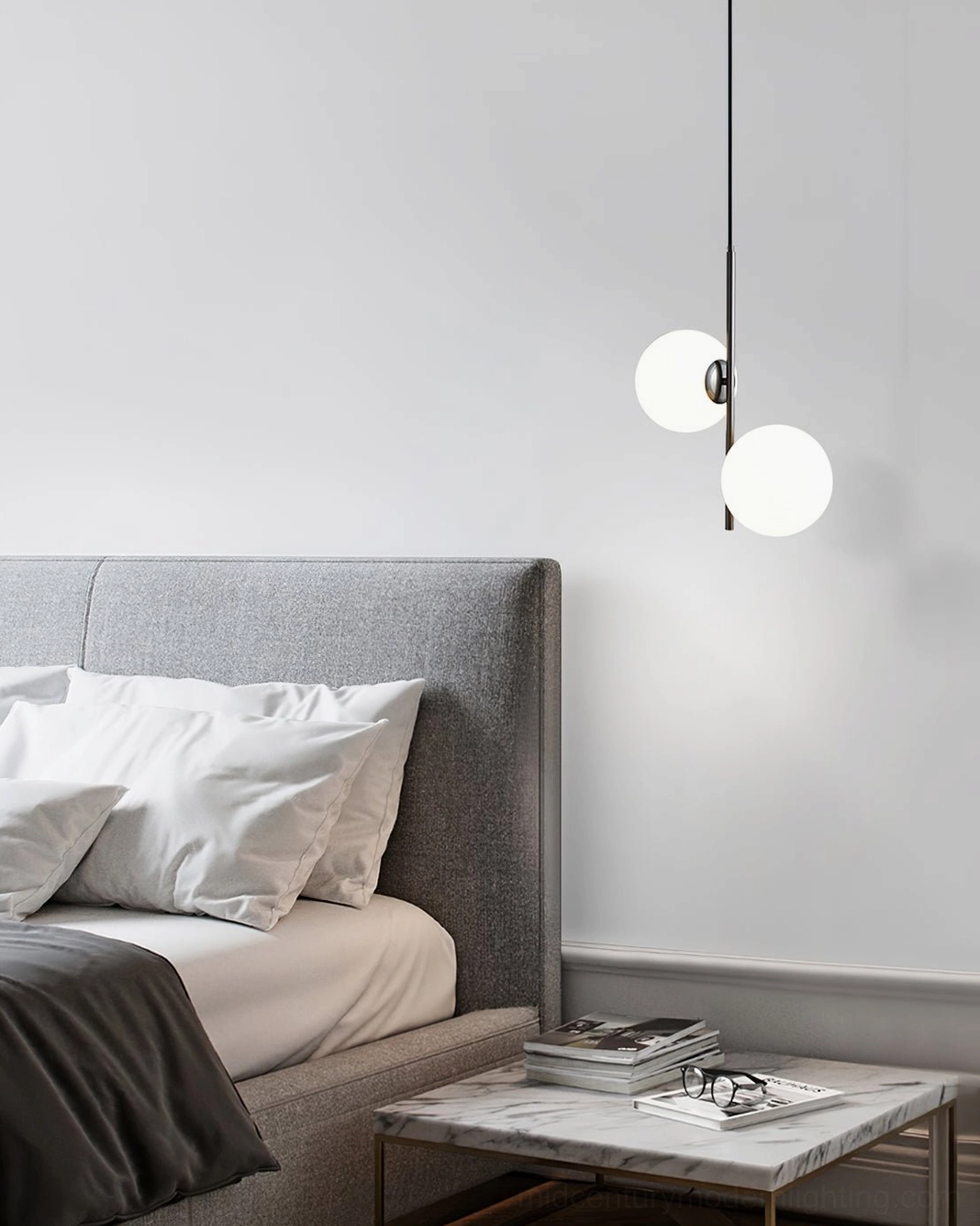 Castell mid-century modern pendant lamp with frosted glass globes viewed at eye level in contemporary master bedroom with marble accents
