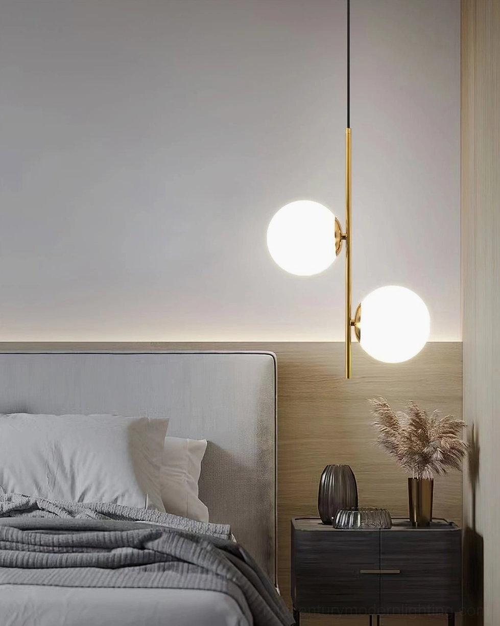 Mid-century Castell pendant light with frosted glass globes and brass hardware installed in minimalist Nordic bedroom interior design