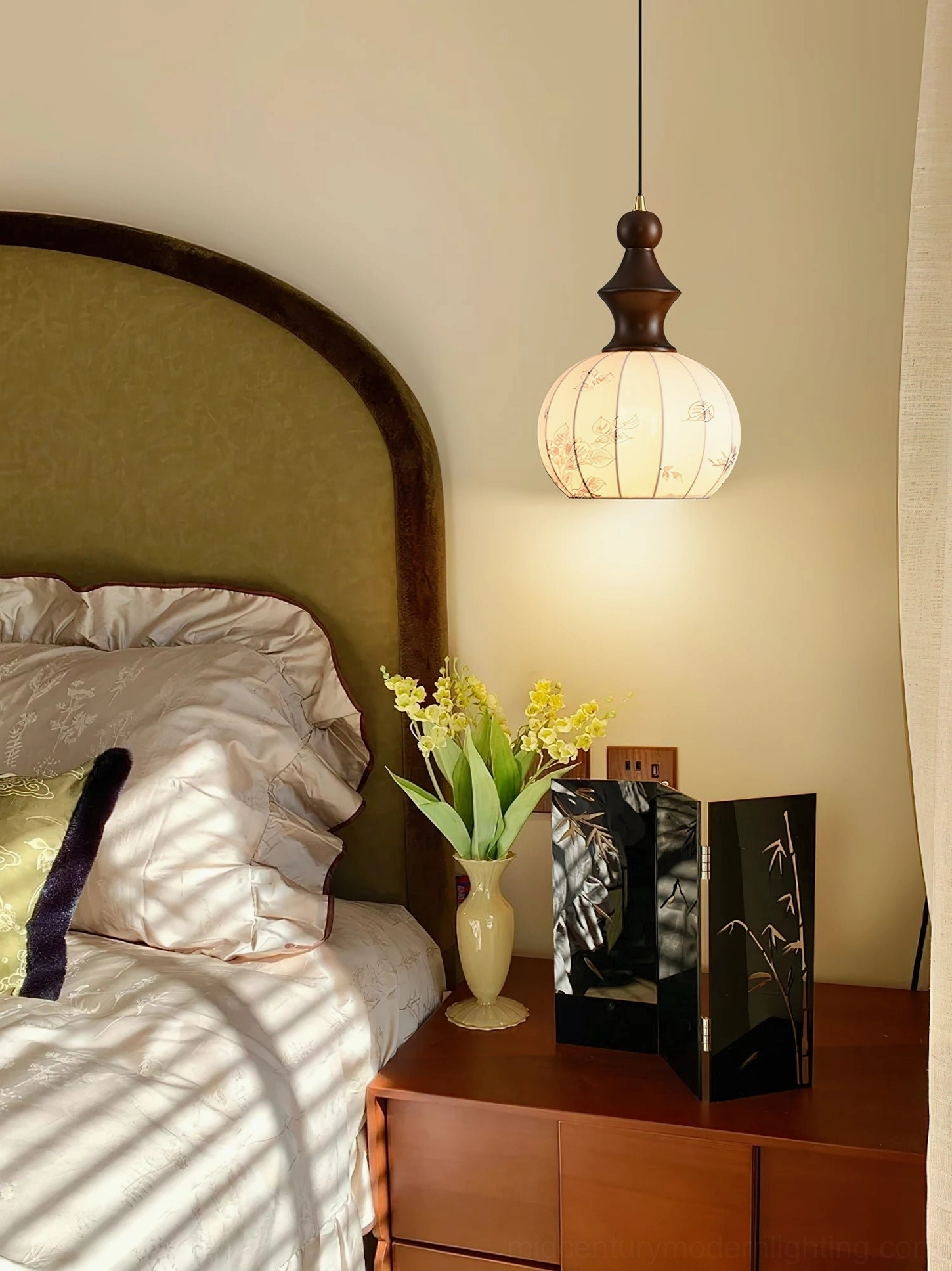 Castiglioni pendant lamp suspended above wooden bedside table in cozy vintage-style bedroom interior setting