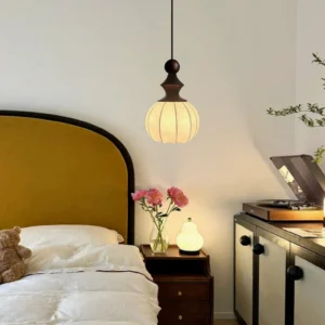 Castiglioni pendant light installed in vintage bedroom creating warm ambient lighting above nightstand with mid-century modern décor
