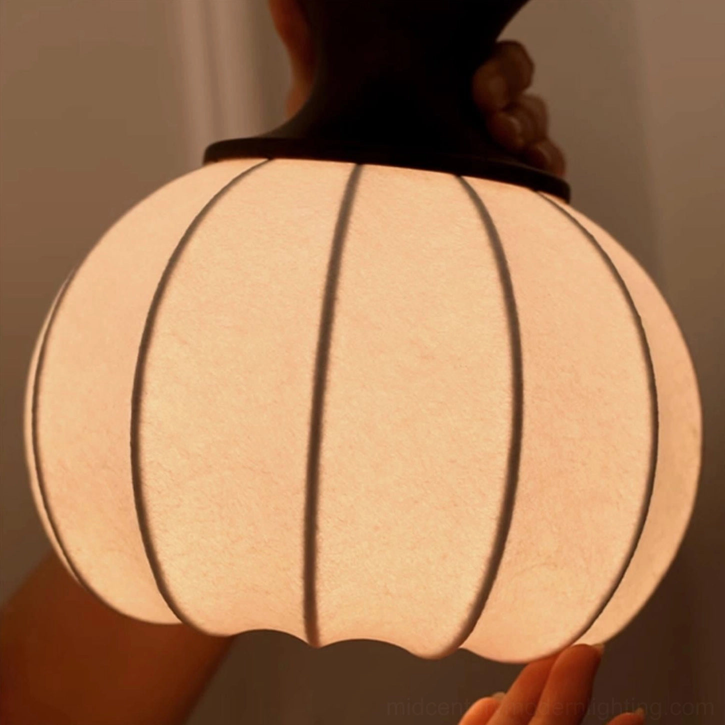 Castiglioni pendant light showing complete wooden and fabric construction with warm glow perfect for dining and entryways