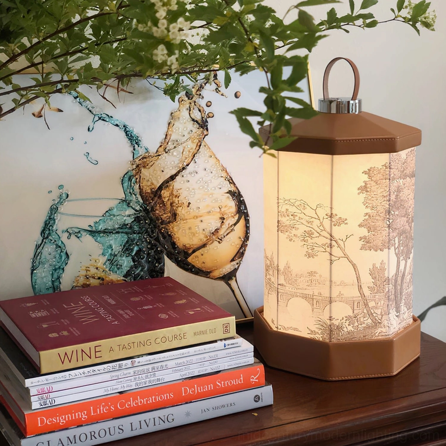 Illuminated Castle vintage landscape printed table lamp on living room side table with stacked wine books and wall art, showing warm LED light output and decorative placement