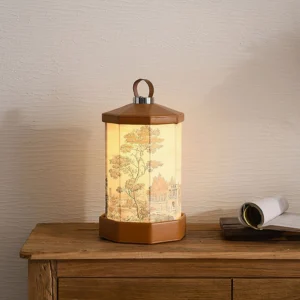 Warm glowing Castle cordless table lamp on bedroom wooden nightstand beside stacked stationery, demonstrating ambient lighting in bedroom interior design setting