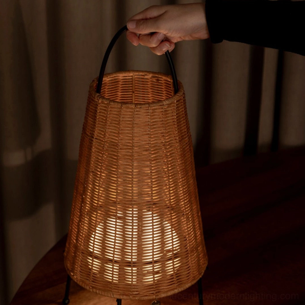 Low-angle view of Catalina Coastal Table Lamp with patterned light projection on base, dim indoor setting with dark curtains