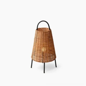Catalina Coastal Table Lamp with woven rattan body and black metal tripod base, front three-quarter studio view