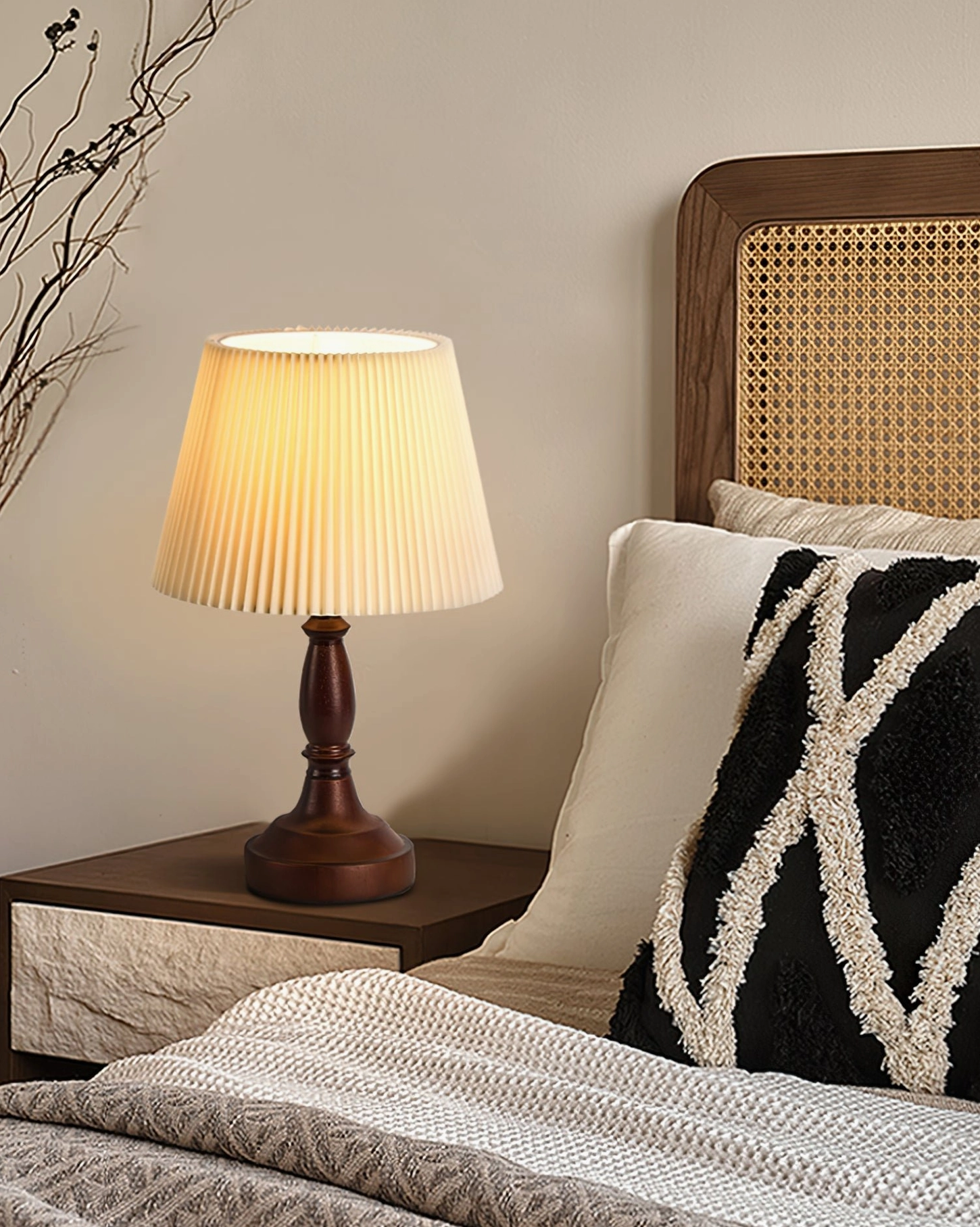 Retro style table lamp on bedroom nightstand beside rattan headboard creating cozy vintage bedroom retreat