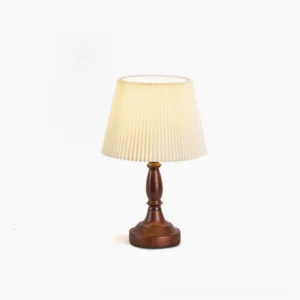 Catelyn mid-century modern table lamp with walnut wood base and pleated white fabric shade on pure white background