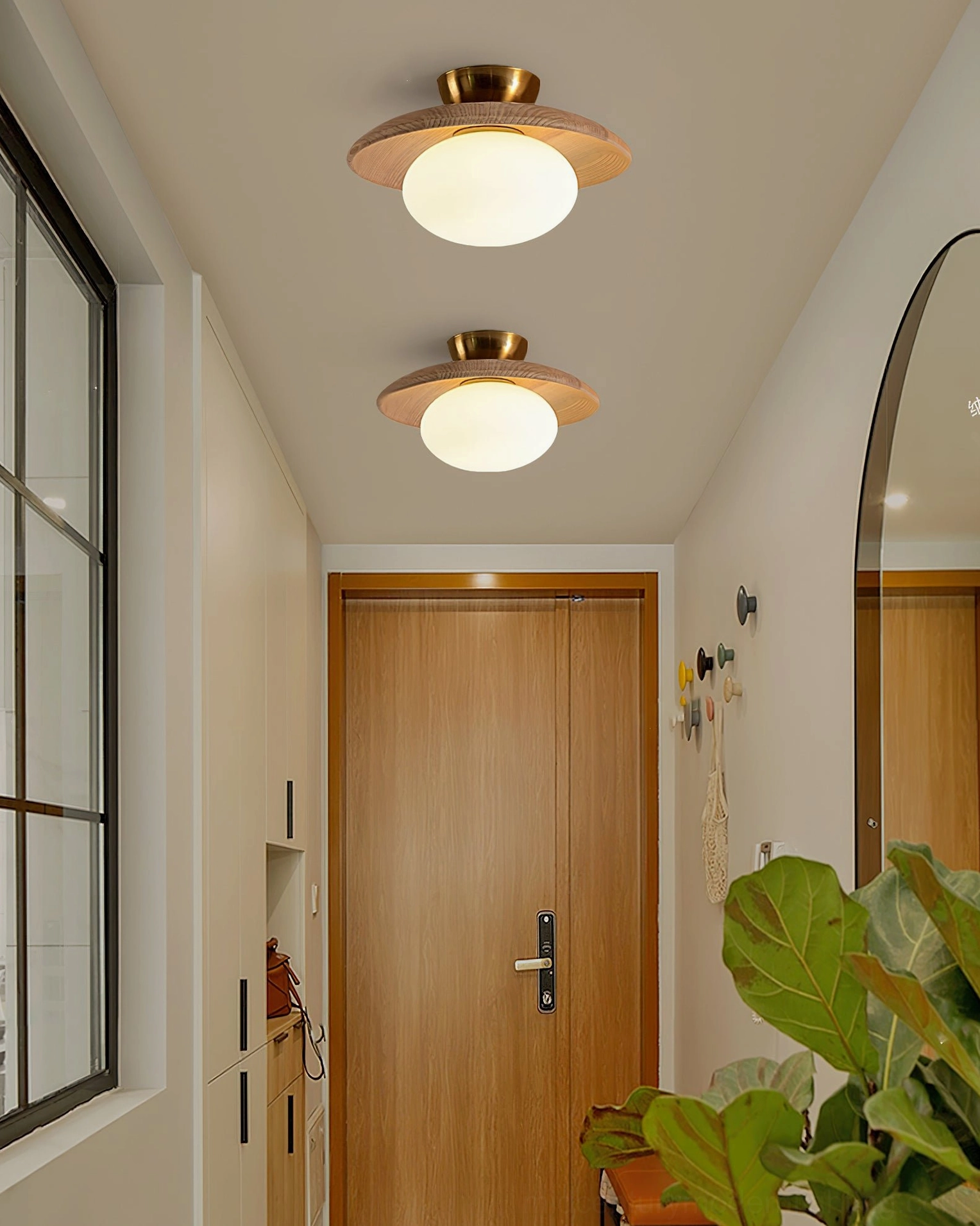 Pair of Cathy ceiling lamps installed in modern residential hallway with light wood finishes