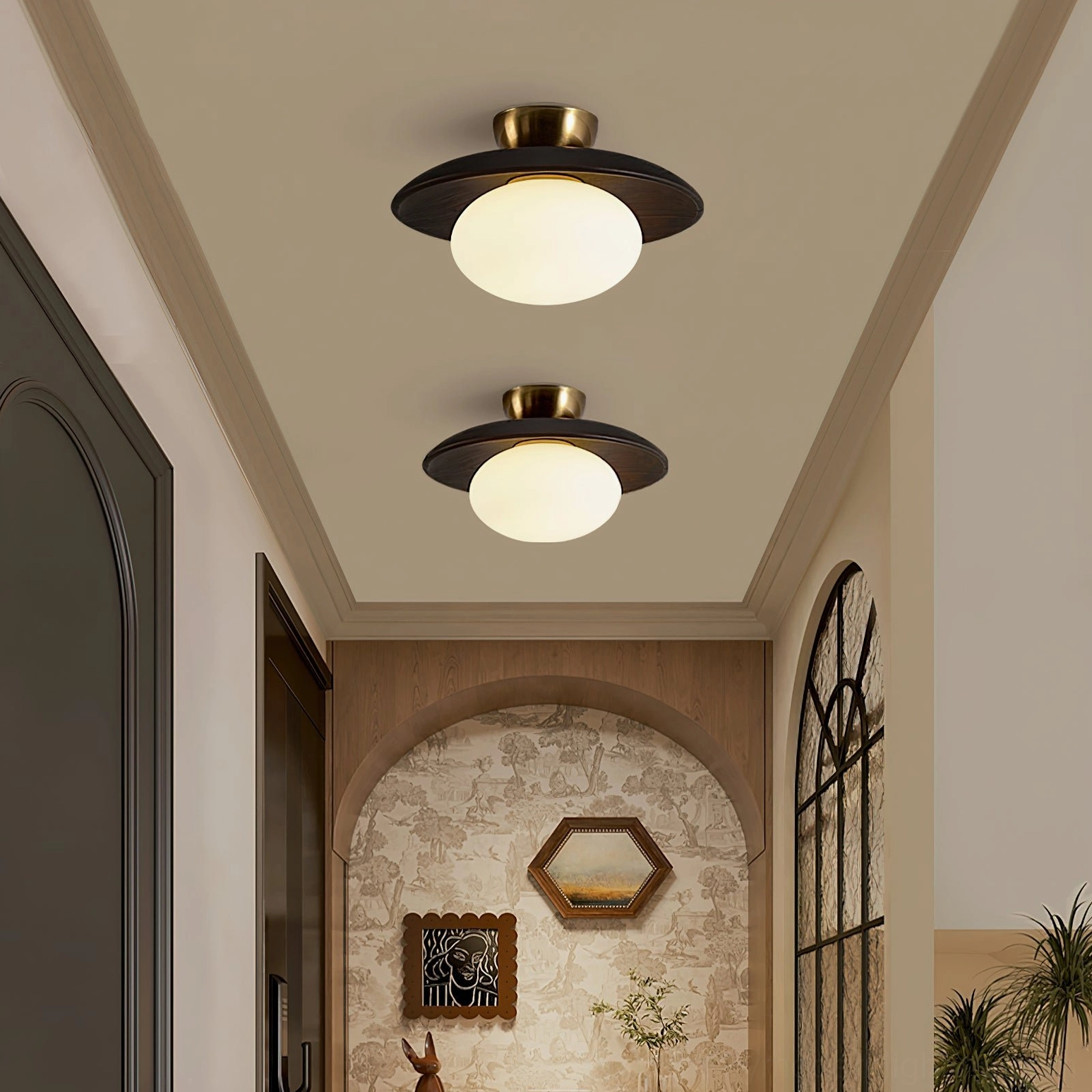 Pair of Cathy lamps with dark wood shades installed in rustic arched entryway with warm glow