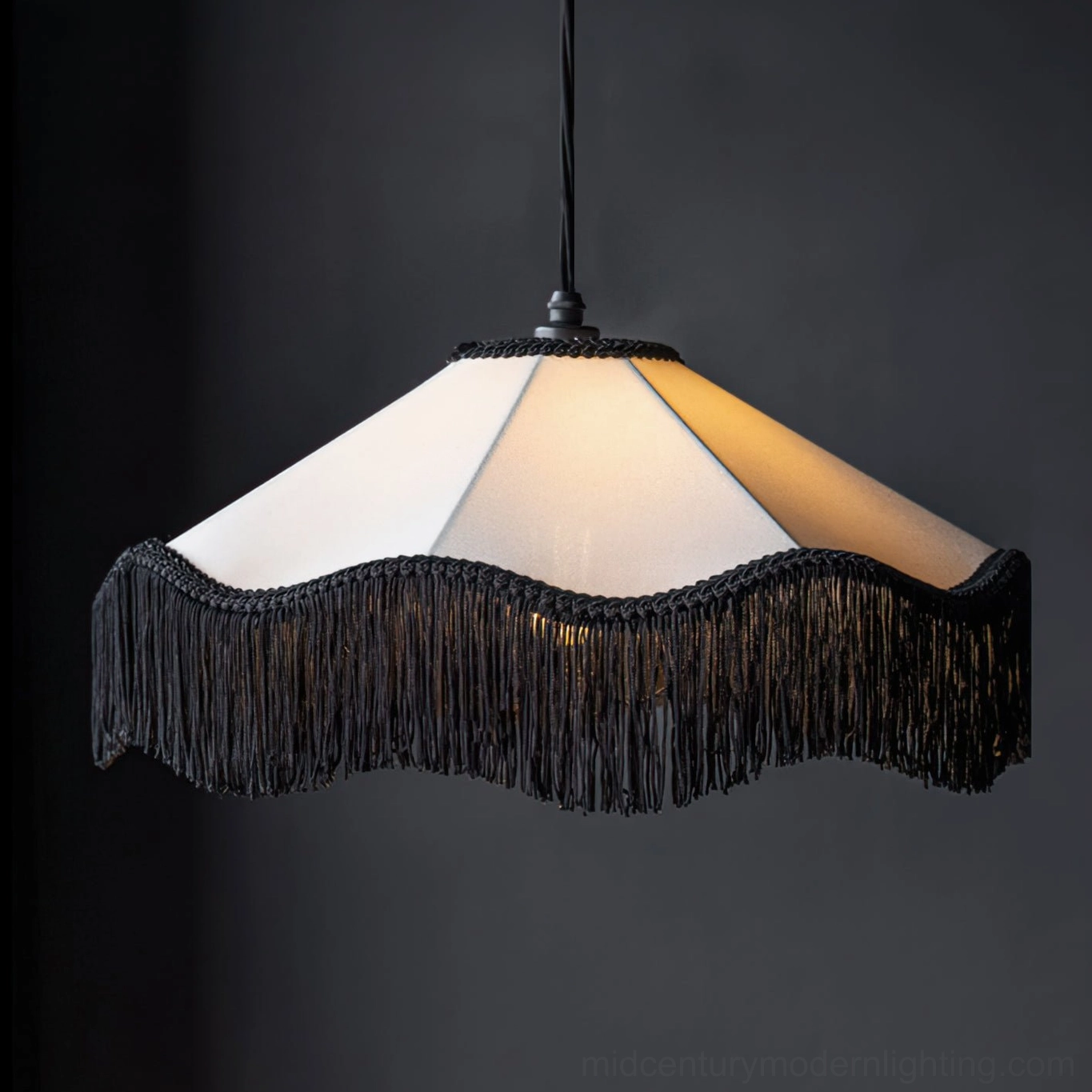Close-up detail of Cecile Tassel Pendant Lamp showing full black tassel trim around linen fabric shade with warm ambient lighting