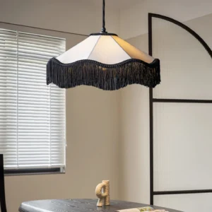 Cecile Tassel Pendant Lamp suspended in minimalist dining room with window blinds, showing wavy fabric shade and black tassel edge decoration