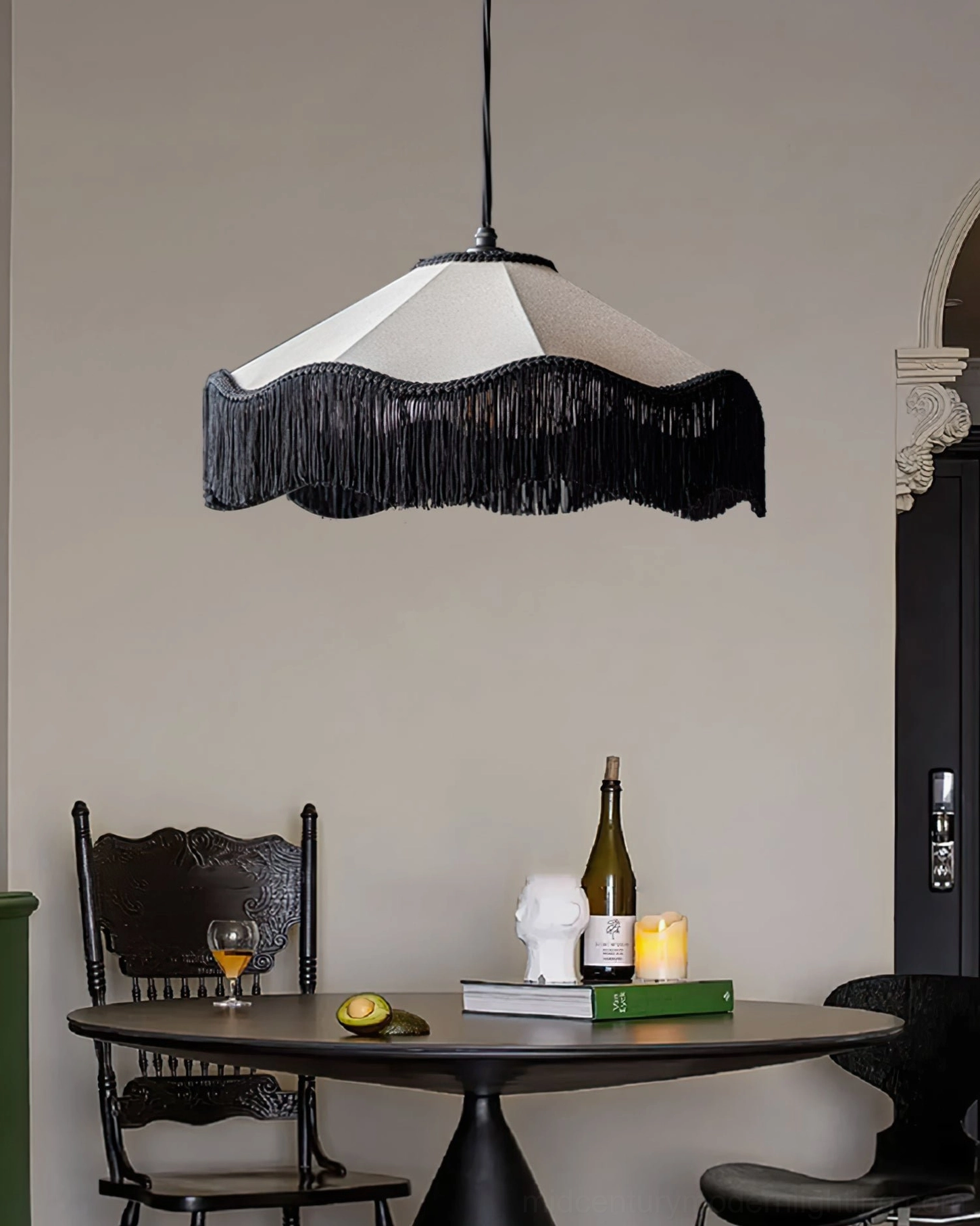 Cecile Tassel Pendant Lamp in small round dining area with tabletop styling including wine bottle, candle and decorative sculpture
