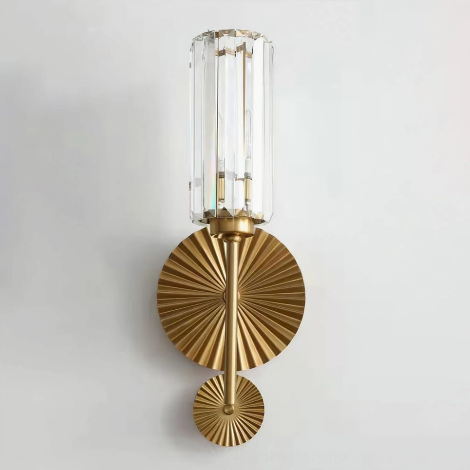 Direct frontal view of Cecily glass wall sconce with tall ribbed crystal cylinder and brass metal base plate