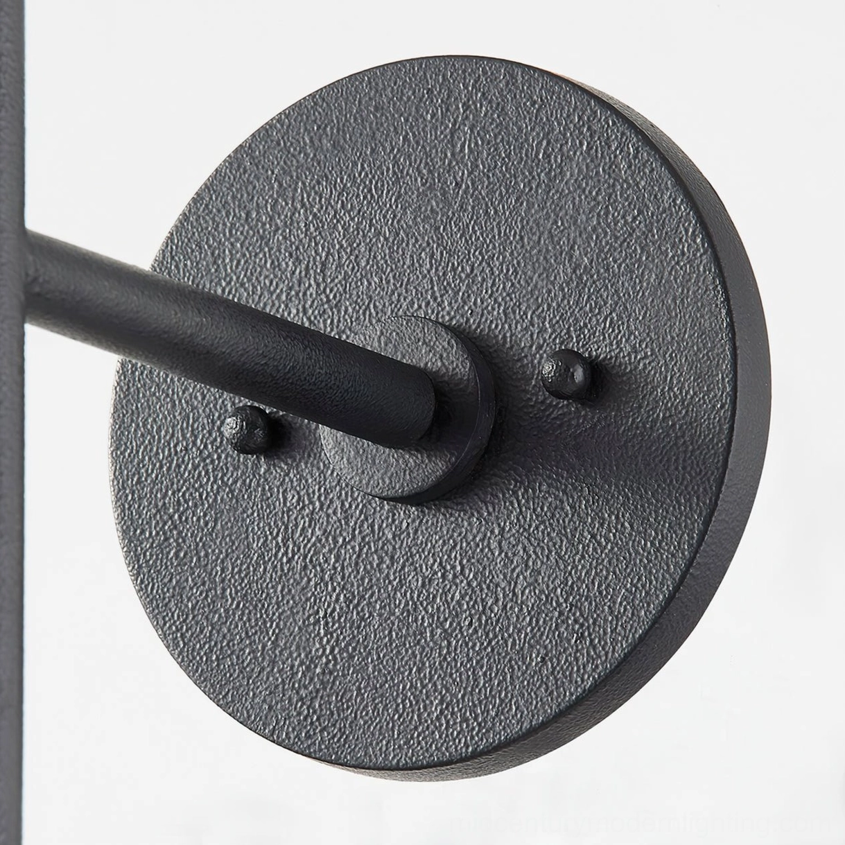 Cedar sconce wall mounting plate detail showing textured black finish, precision screw holes, and installation hardware