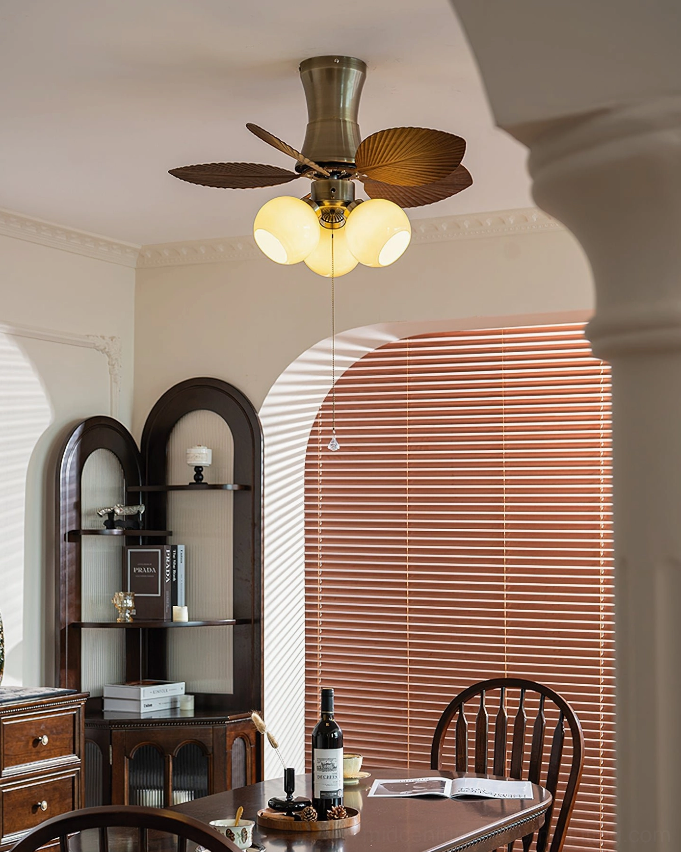 Bronze metal frame ceiling fan light with crystal pull chain and globe light fixture close-up