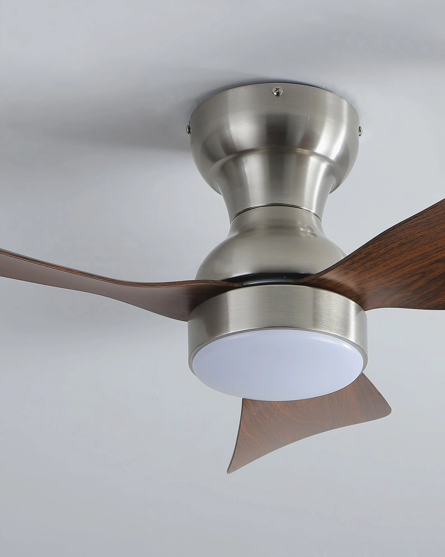 Close-up detail of ceiling fan light motor housing, blade mechanism, and integrated LED light module in contemporary fixture
