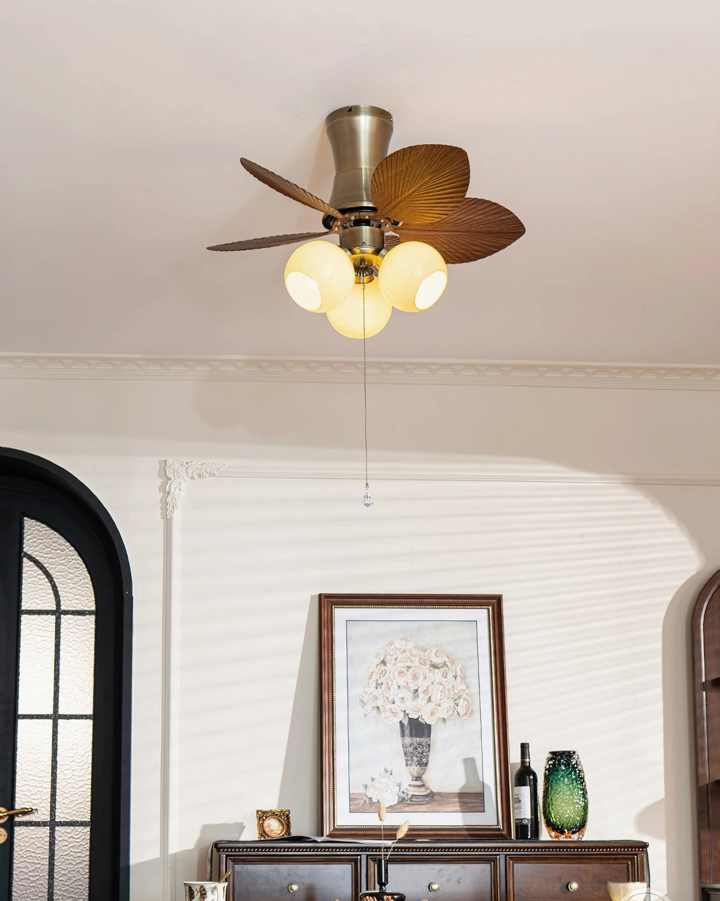 Palm-shaped ceiling fan blade design detail showing tropical-modern artisanal craftsmanship