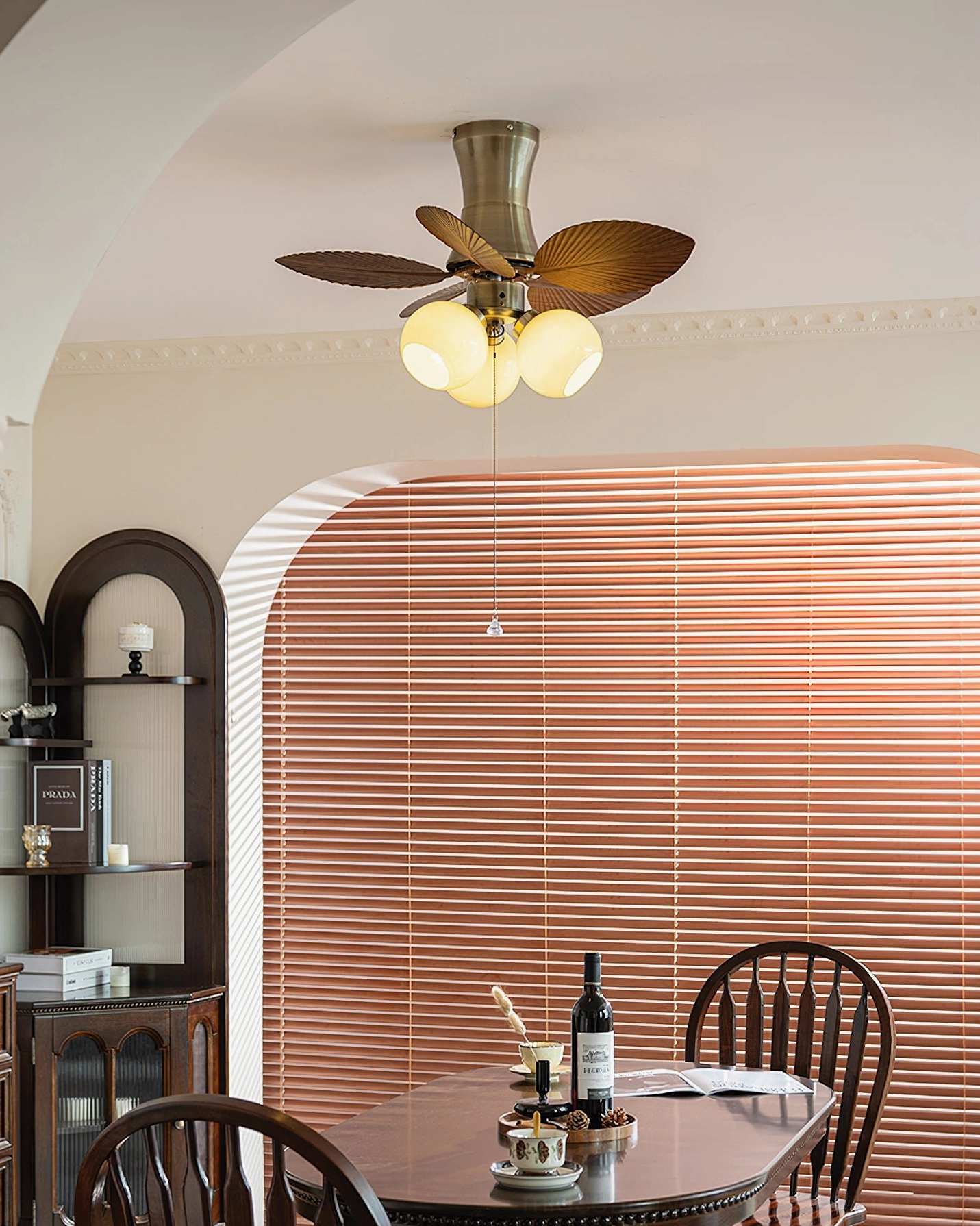 Walnut color ceiling fan light finish shown in warm bedroom lighting ambiance