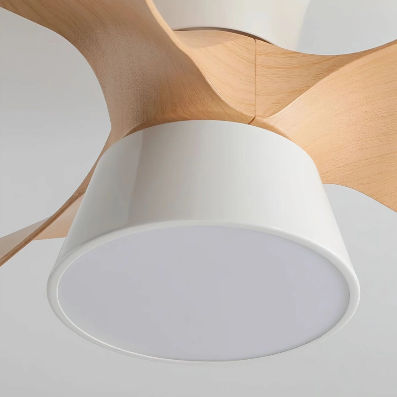 Close-up detail of wood grain rubber blades and white metal assembly of modern DC ceiling fan light