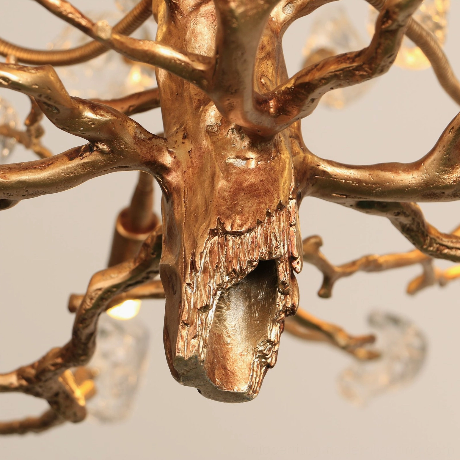 Ceiling installation of brass gemstone branch chandelier with suspended crystal accents