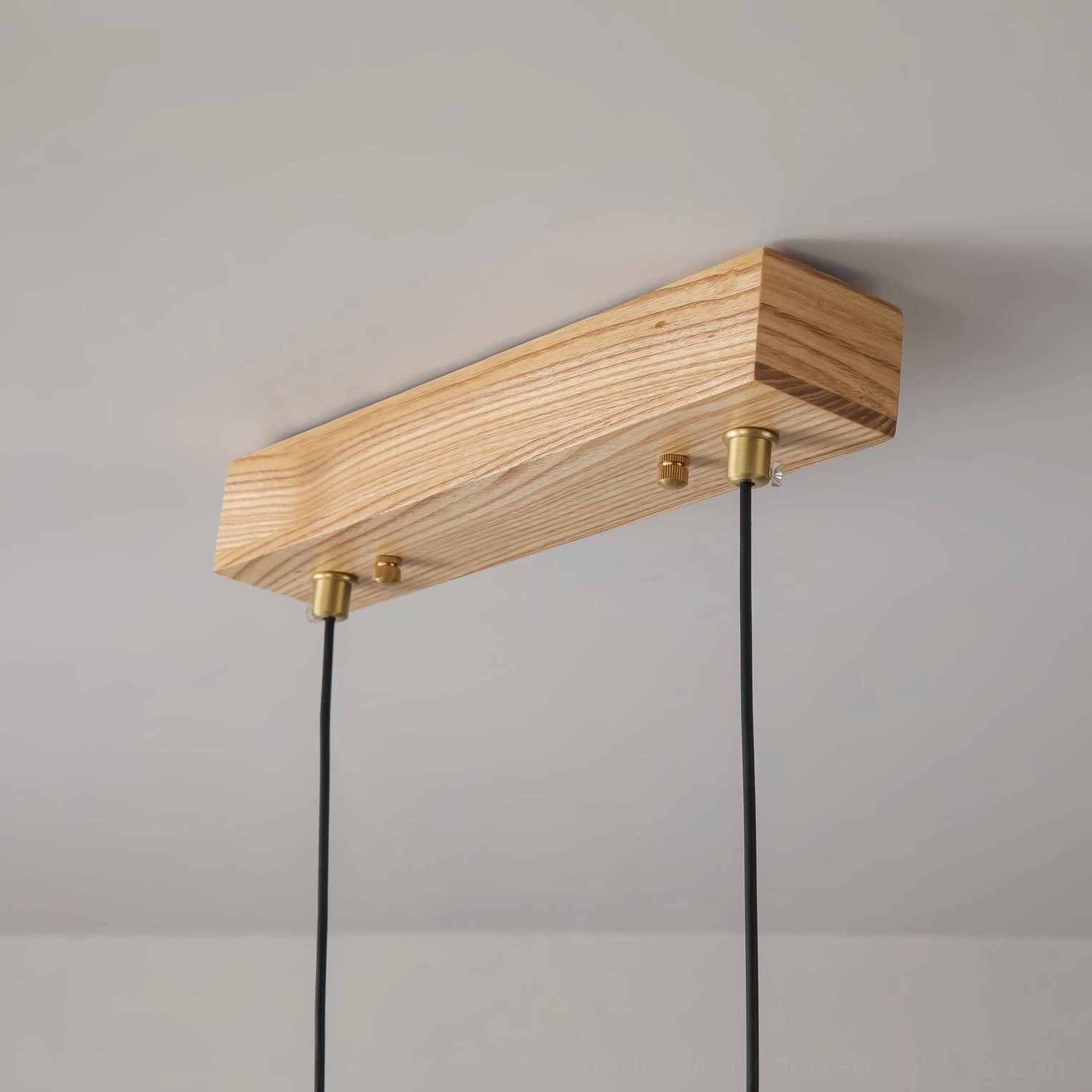 Close-up of linear pendant ceiling mounting base with solid wood and brass metal fixtures detail view