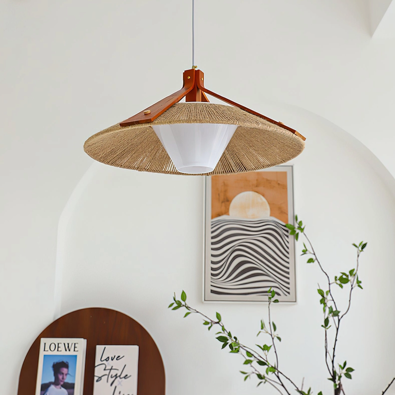 Low angle view of ceiling-mounted Millier pendant in architectural space with arched wall and modern decor, downward-facing frosted shade