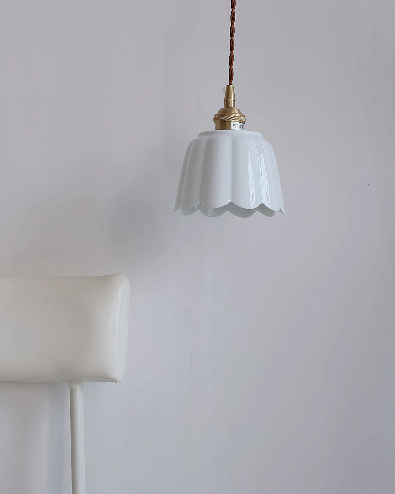 White ceramic scalloped pendant light hung in minimalist dining area with modern Nordic décor
