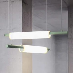 Dual Celeste linear pendant lamps with sage green metal accents suspended in contemporary interior space