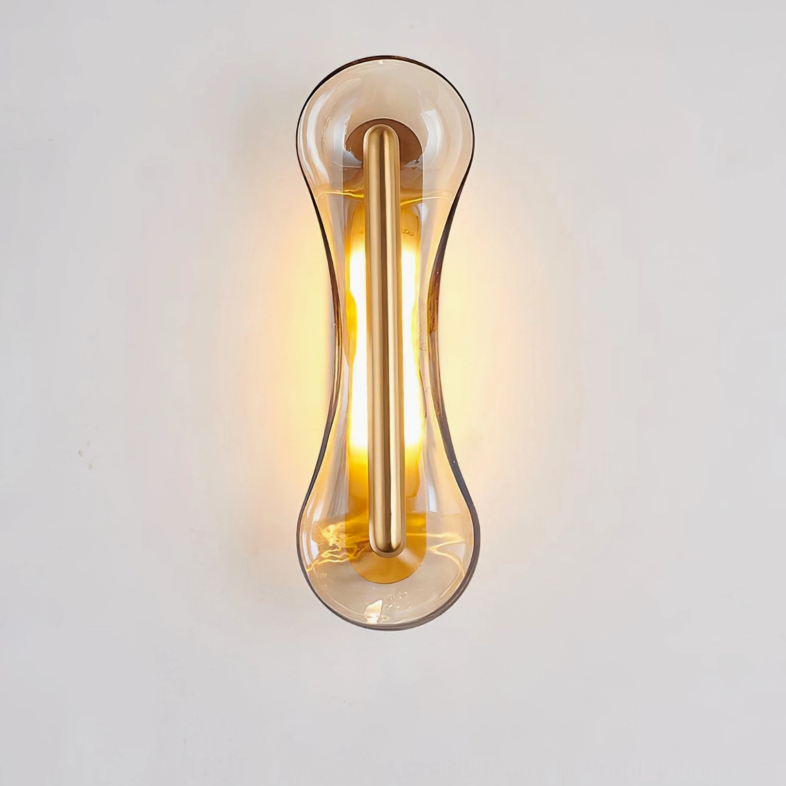 Silver Cell Wall Lamp with Cognac glass glowing warm illumination on white background showcasing luminous glass quality