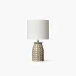 Handcrafted ceramic patterned table lamp with intricate Malay geometric design on white background, bohemian modern lighting accent