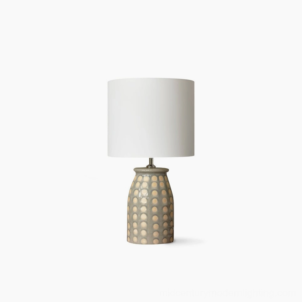 Handcrafted ceramic patterned table lamp with intricate Malay geometric design on white background, bohemian modern lighting accent