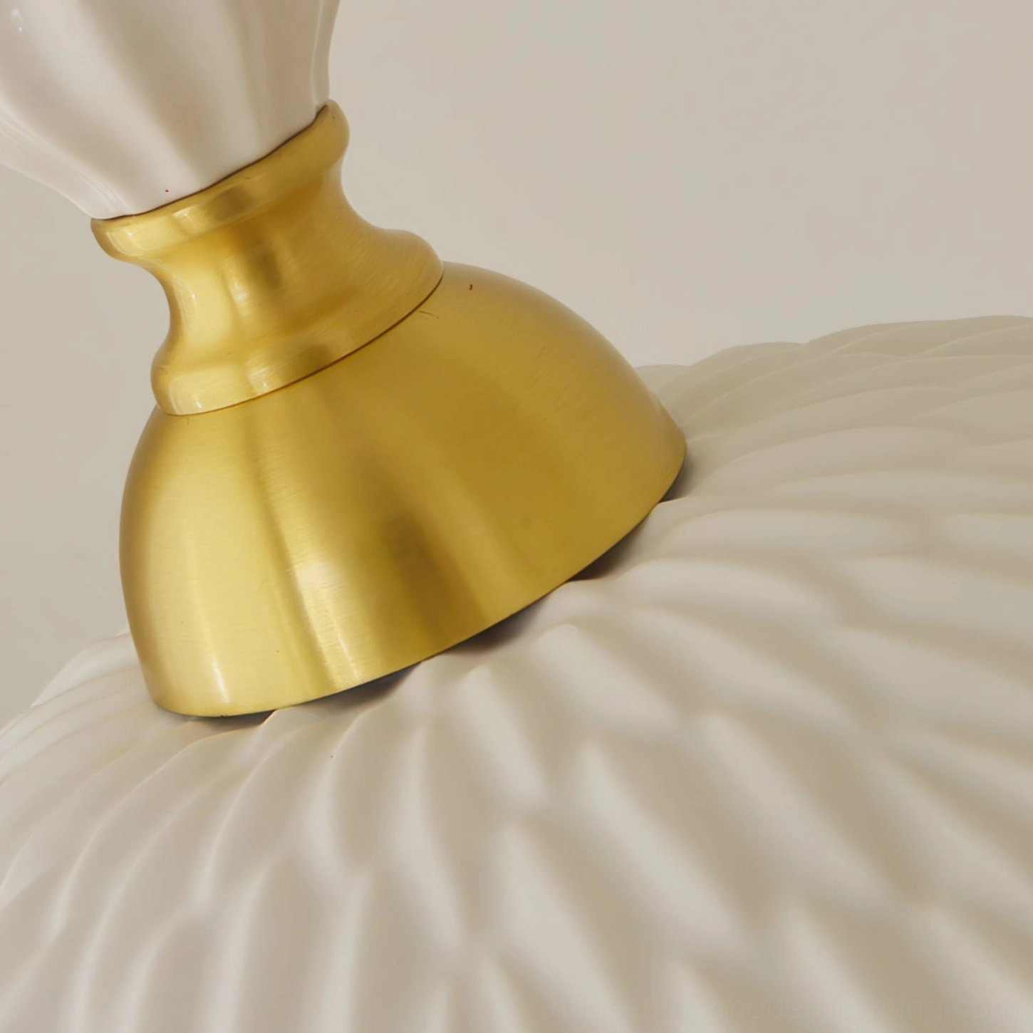 Brass fixture and ridged ceramic surface detail of handcrafted pendant lamp hardware