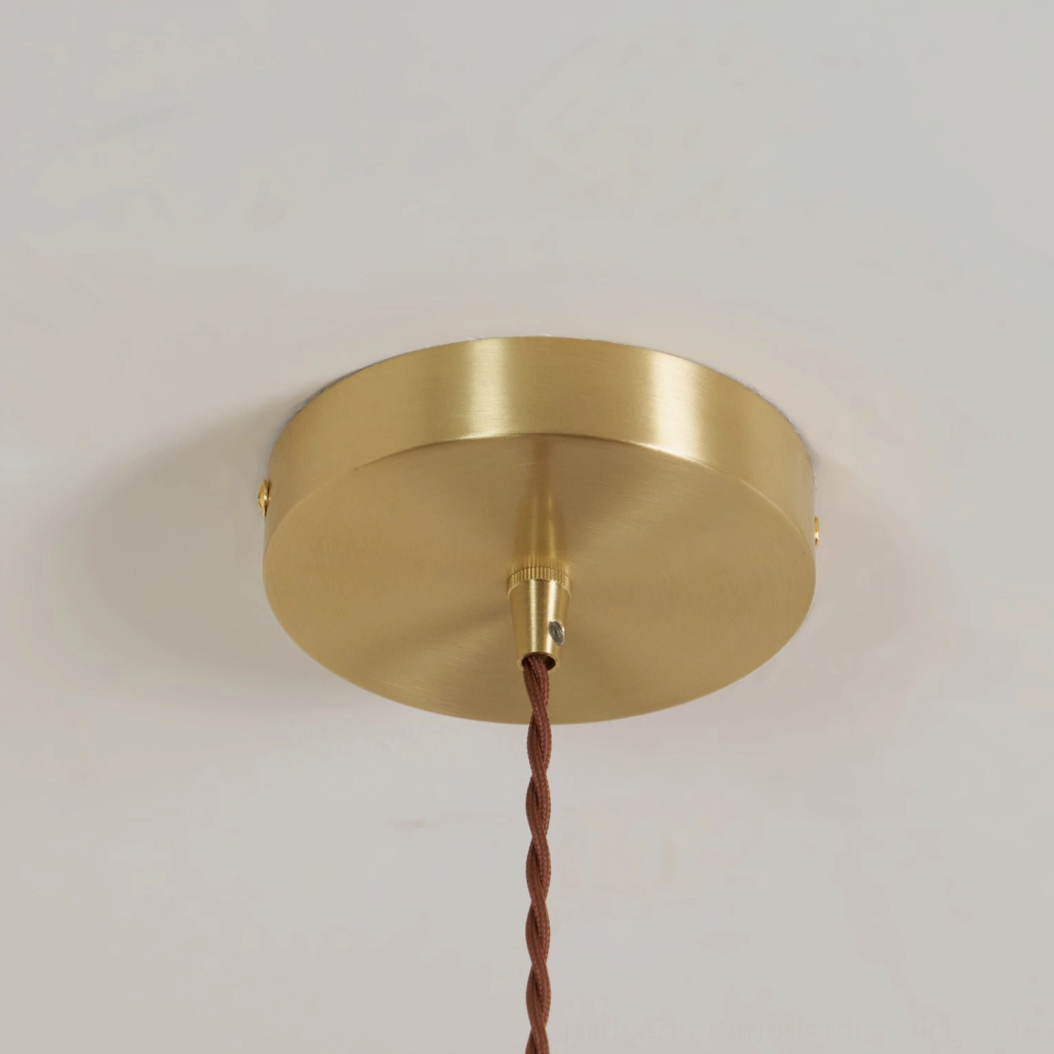 Ceramic pendant light installation showing hardwired ceiling mount and cord suspension