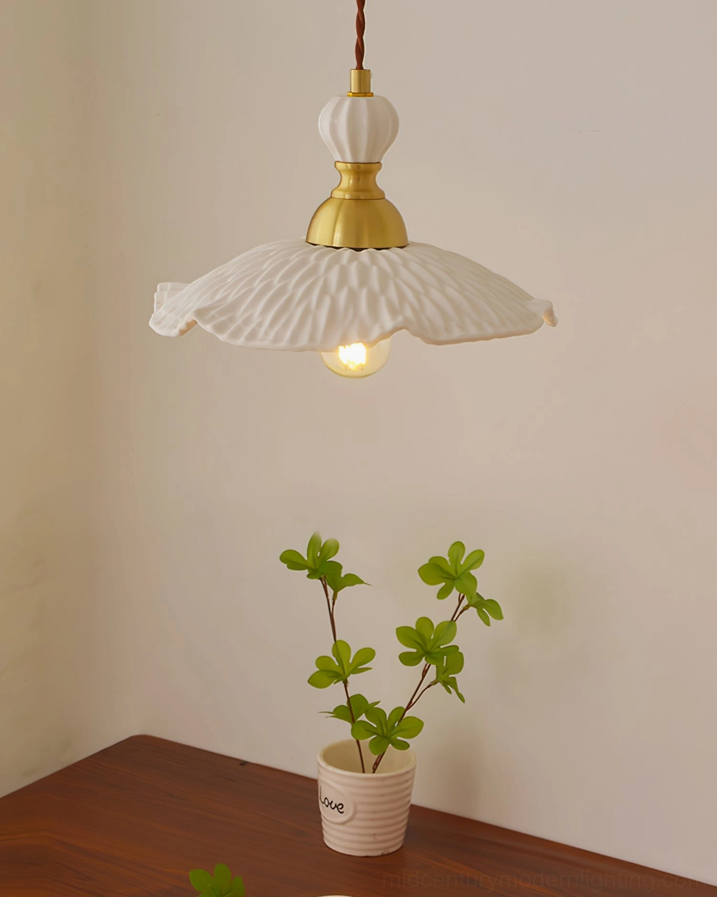 Ceramic pendant lamp installation detail showing suspension mechanism and cord attachment