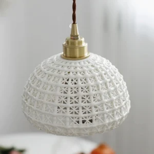 Close-up overhead view of handwoven ceramic pendant lamp showing detailed lattice weave texture and interior bulb socket