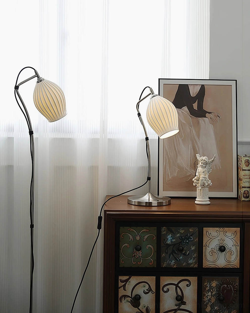 Pair of ceramic ribbed arc lamps with black metal poles and warm yellow ribbed shades displayed on dresser