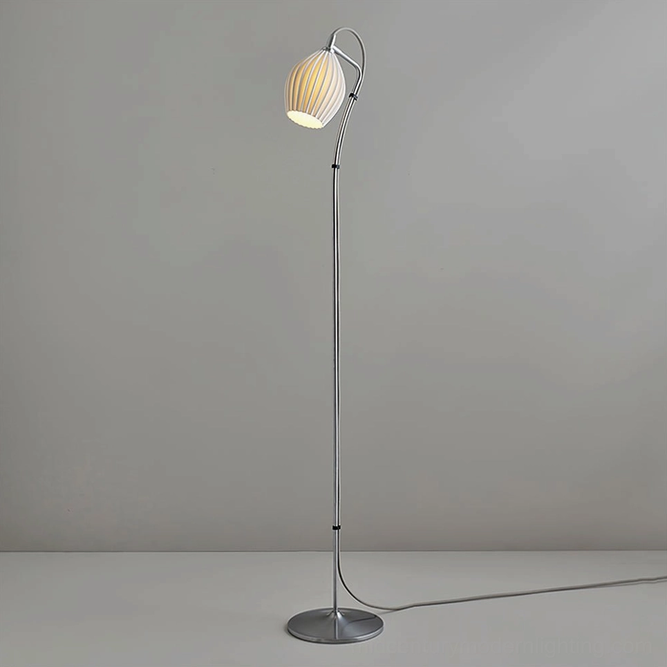 Modern ceramic ribbed floor lamp creating dramatic light and shadow play in evening room ambiance