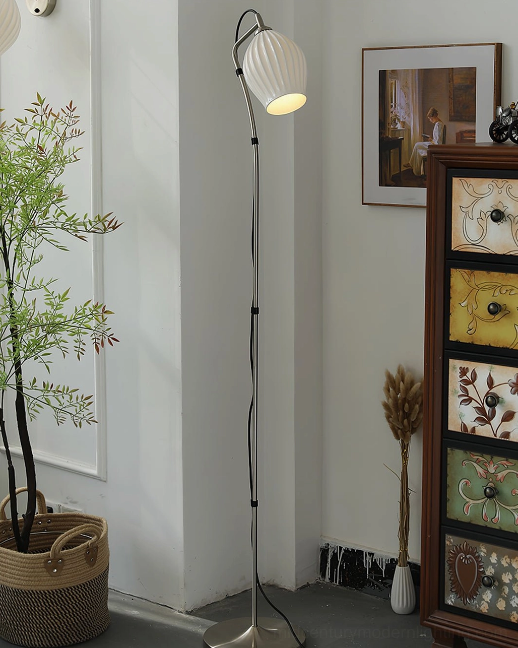 Ceramic ribbed floor lamp with silver metal pole and warm yellow ribbed shade in retro living room with decorative cabinet