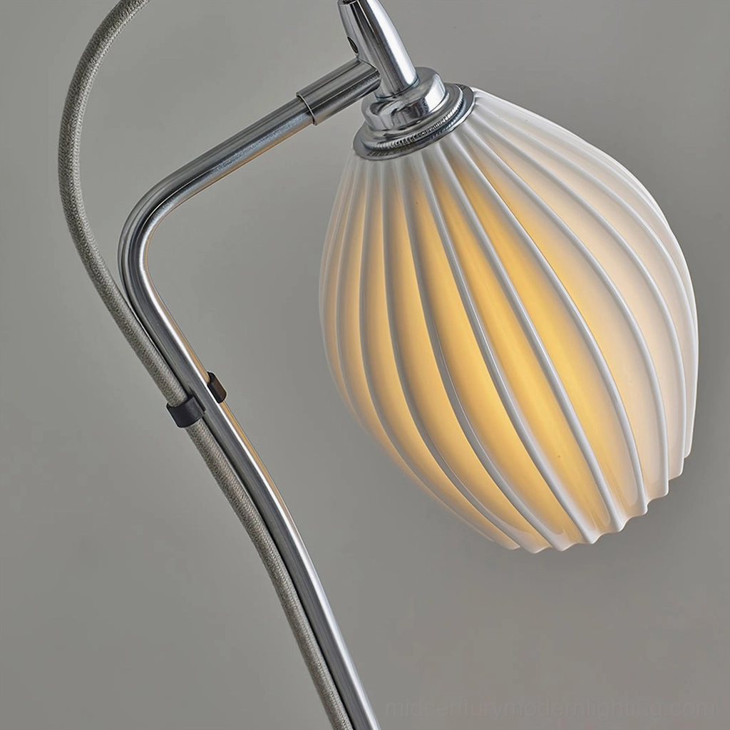 Sand nickel ceramic ribbed arc floor lamp in minimalist interior with contemporary art and light wood furniture