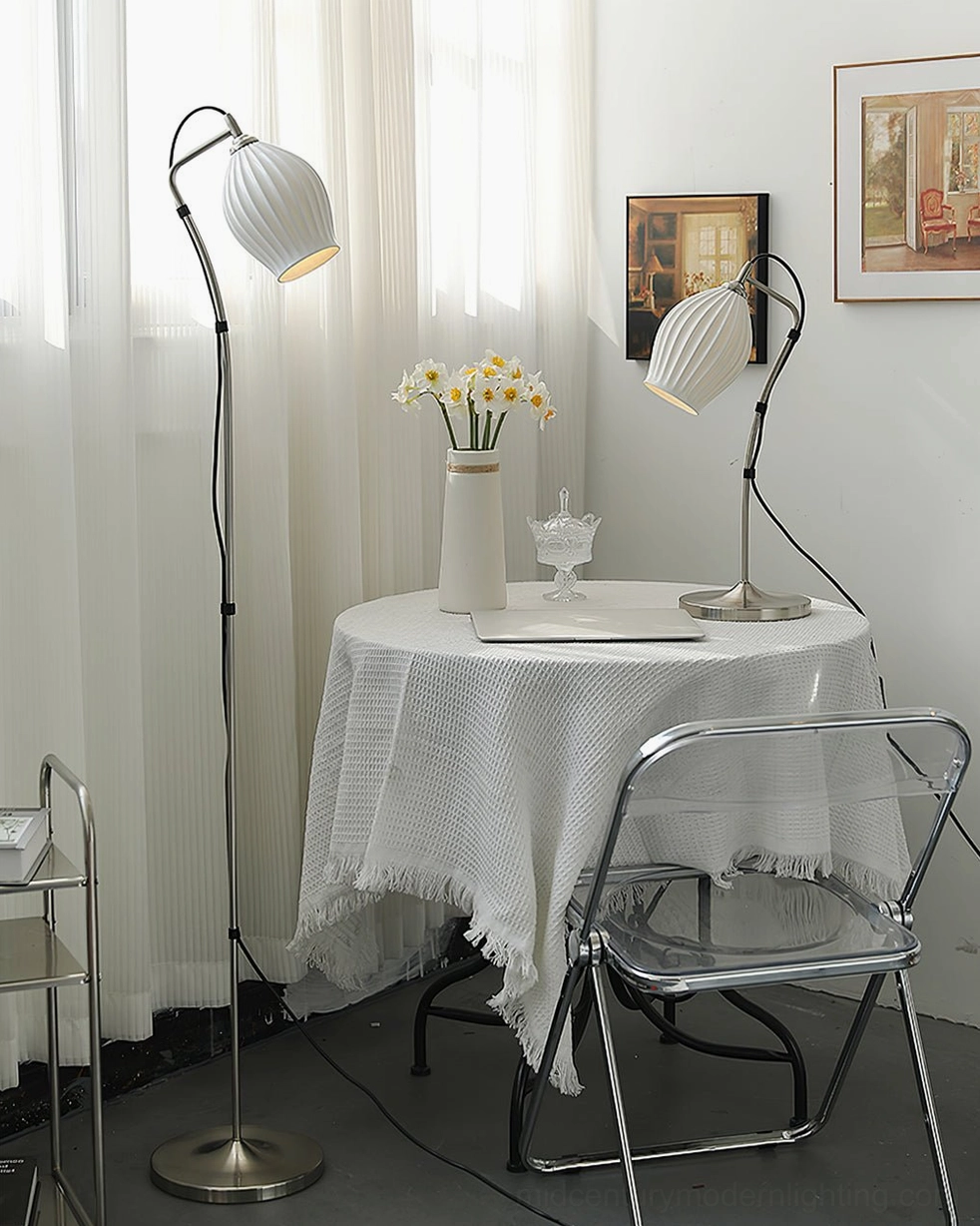 Modern arc floor lamp and matching table lamp with ribbed ceramic shades in bright white French vintage minimalist dining nook