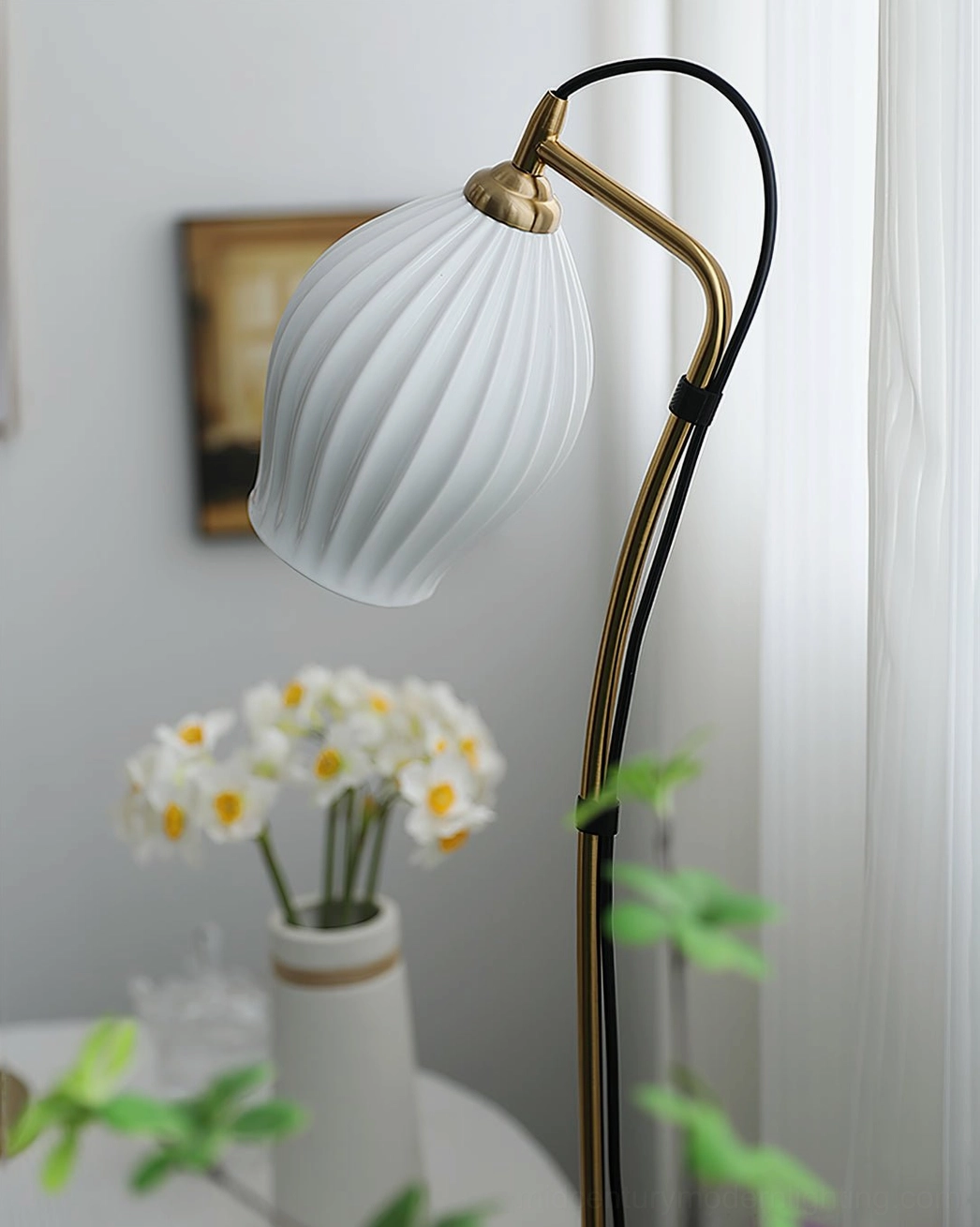 Close-up detail of white ceramic ribbed shade with gold metal hardware showing sculptural texture and light diffusion