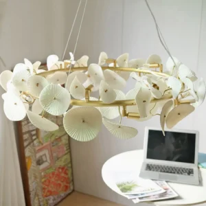 Ceramic wreath pendant light hanging in modern home office with laptop and side table, eye-level perspective showing integrated interior design